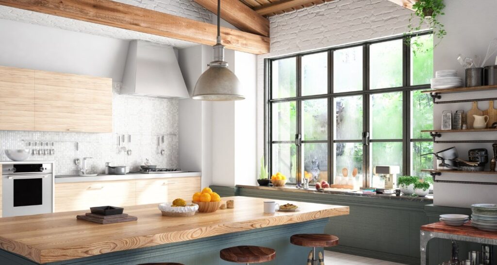 Modern kitchen with wooden island, metal stools, large window, and industrial pendant light. Includes open shelving and fresh fruit on counters.